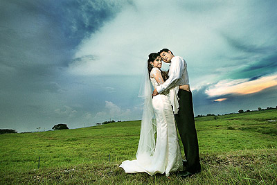 http://demersbanquethall.com/wp-content/uploads/2010/11/couple-at-outdoor-wedding-grass-clouds.jpg